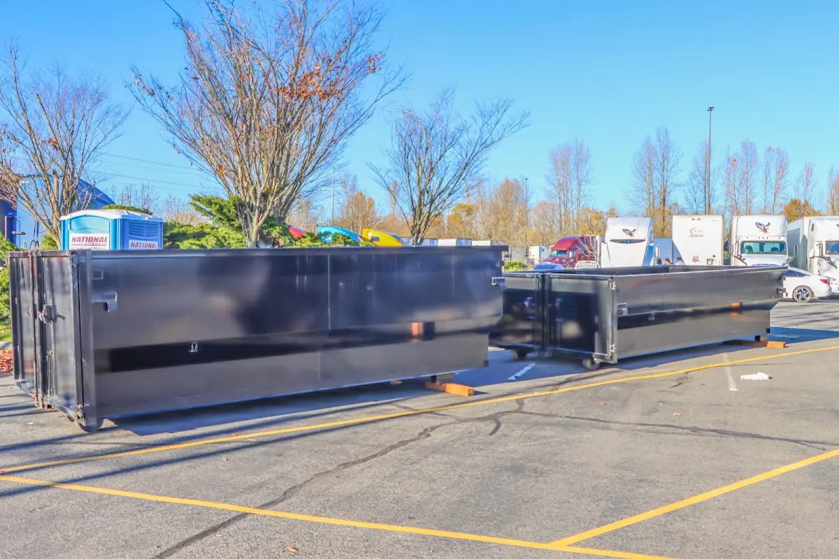 Professional dumpster rental service with roll-off container on residential driveway in Williston Park